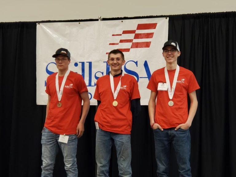 students with medals at an automotive competition