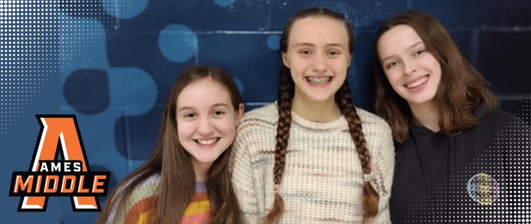 three middle schoolers smile for a photos