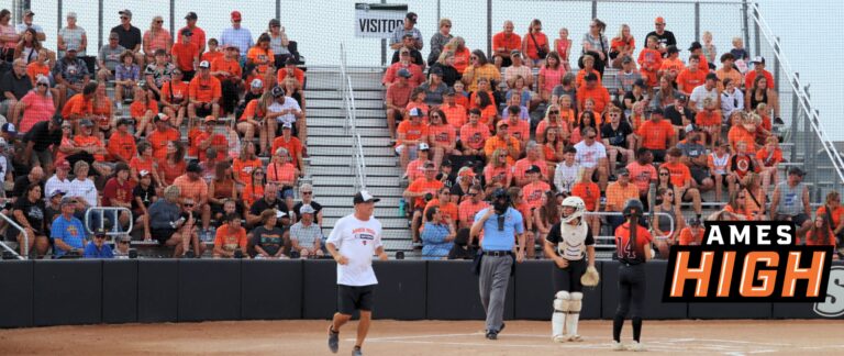 General view of the Ames High section at a softball game, Little Cyclone fans are seen wearing orange